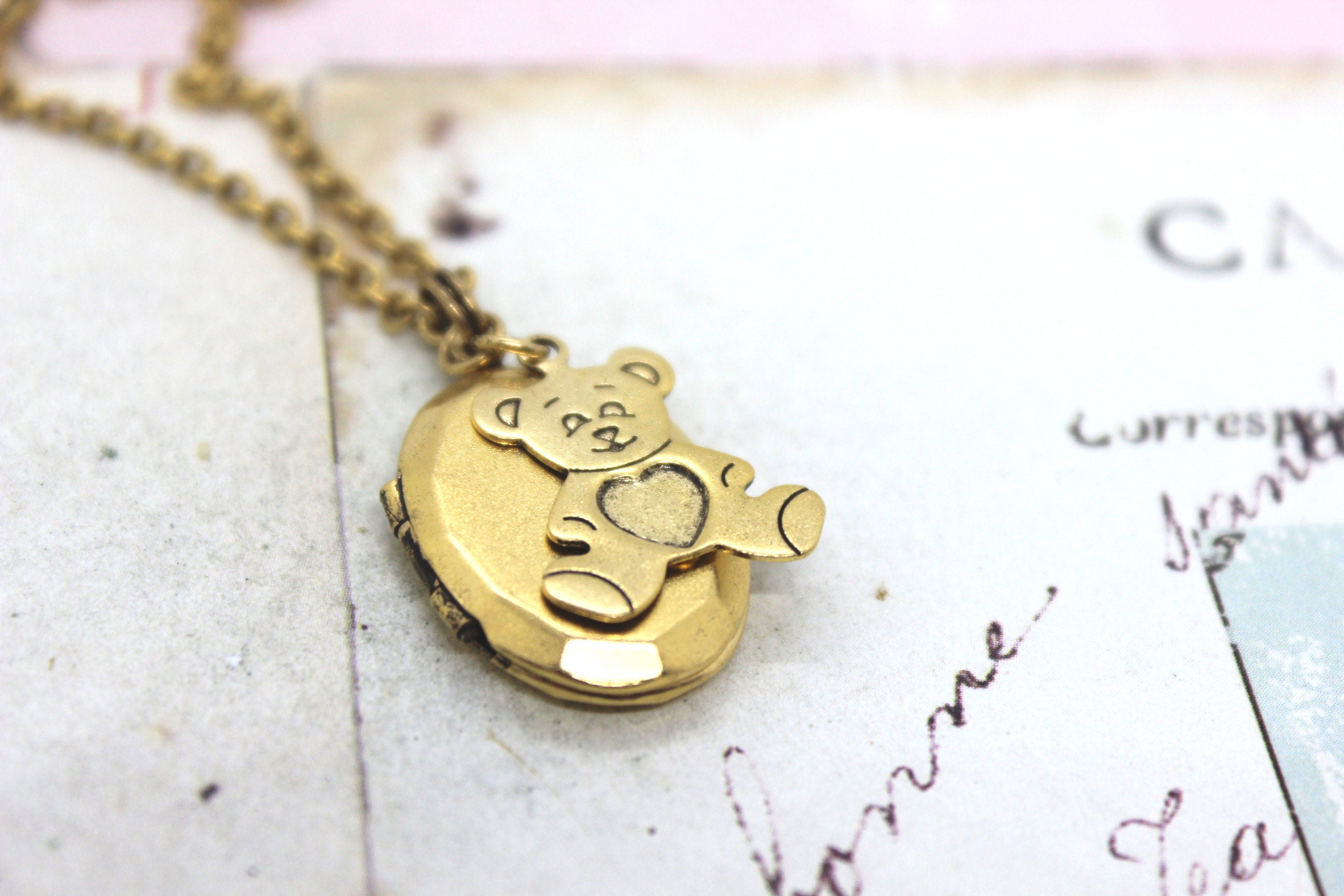 teddy bear. locket necklace. gold ox jewelry with heart on bear