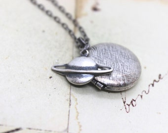 planet. round locket necklace. in silver ox with Saturn