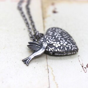 hummingbird. heart locket necklace. in silver ox with floral locket