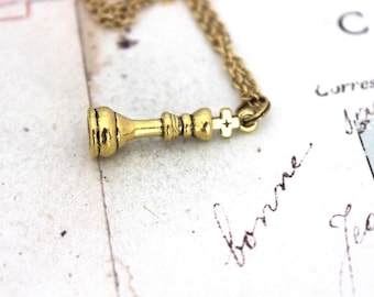 king chess piece necklace. gold tone