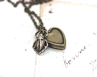scarab. heart locket necklace. in brass ox