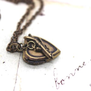 tiny airplane. locket necklace. in brass ox image 2