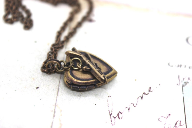 tiny airplane. locket necklace. in brass ox image 2