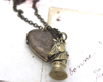 knight. heart locket necklace. in brass ox with etched lines locket chess piece