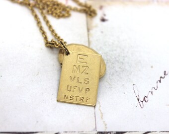 eye chart locket necklace. in gold ox oval locket