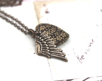 wing. heart locket necklace. in brass ox with floral pattern