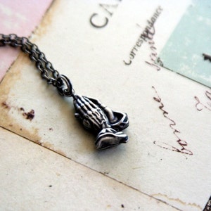 praying hands. necklace. silver ox