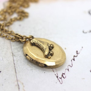 roller skate. locket necklace. gold ox oval
