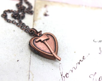 axe. heart locket necklace. copper ox