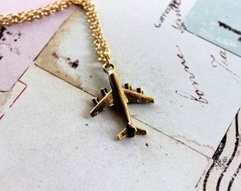 in flight. airplane necklace. gold tone