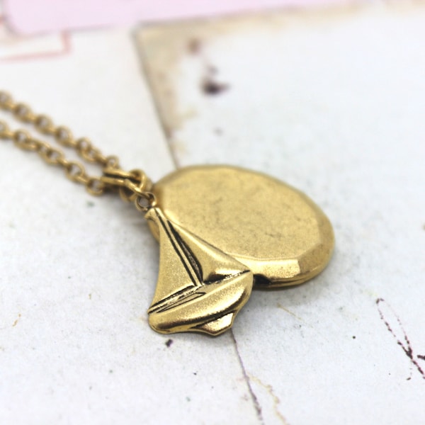 sailboat. locket necklace. gold ox jewelry