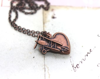 biplane. heart locket necklace. copper ox