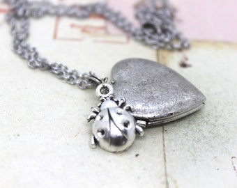 ladybug. heart locket necklace. in antiqued shiny silver tone with stars jewelry