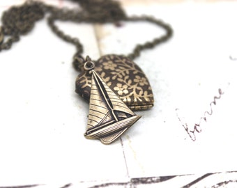 sailboat. heart locket necklace. in brass ox with floral pattern