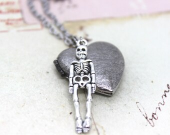 skeleton. heart locket necklace. in antiqued shiny silver tone with etched lines