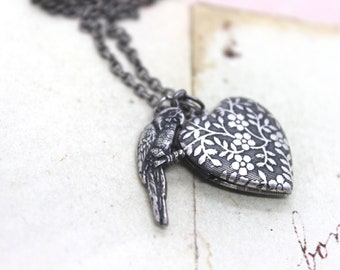 parrot. heart locket necklace. in silver ox with floral locket