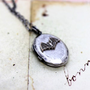 bat. oval locket necklace. silver ox jewelry with silver tone bat destructed