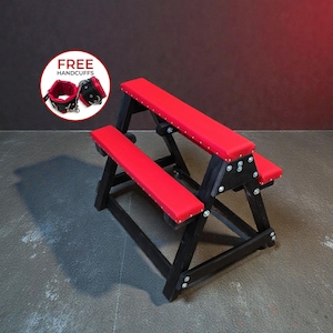May include: A black wooden bench with three red padded seats. The bench is constructed with angled legs and metal hardware. A pair of red and black handcuffs are shown in a circle with the text "FREE HANDCUFFS".