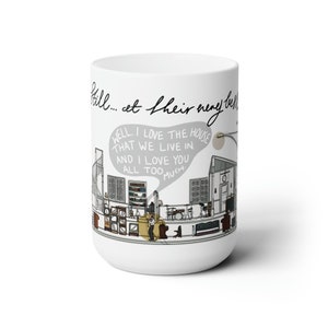 May include: White ceramic mug with a black and white illustration of a house interior. The mug features a speech bubble with the text "WELL. I LOVE THE HOUSE THAT WE LIVE IN. AND I LOVE YOU ALL TOO MUCH."