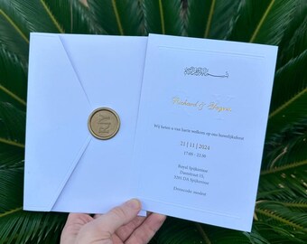 May include: White wedding invitation with gold lettering. The invitation reads "Richard & Sagra" and includes the date "21|11|2024", time "17:00-22:30", location "Royal Spijkenisse, Damstraat 15, 3201 DA Spijkenisse", and dress code "modest".