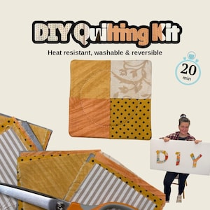 May include: A DIY Quilting Kit featuring a square fabric coaster with four distinct patterns in mustard yellow, orange, and cream. The kit includes fabric pieces, scissors, and instructions for a 20-minute project that is heat resistant and washable.