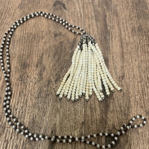 brown tassel necklace on silver strung beads. Similar seen in Brighton