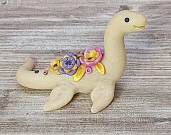 Ivory colored miniature pastel floral Nessie lake monster dinosaur figurine