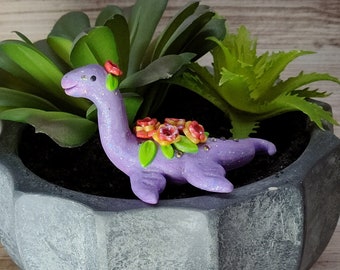 Loch Ness monster with flowers miniature handsculpted sparkly lavender pleisiosaur dinosaur