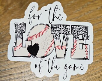 May include: A white sticker with the text "for the LOVE of the game" in a script font. The word "LOVE" has leopard print accents. A baseball with red stitching and a black heart are in the center.