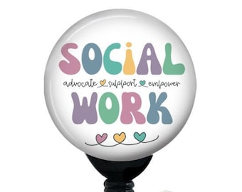May include: A white round badge holder with a black retractable cord and a clear plastic clip. The badge holder features a colorful graphic that says "SOCIAL WORK" with the words "advocate, support, empower" written in smaller font below.