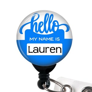 May include: A blue and white retractable badge holder with the text "hello my name is Lauren".