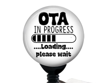 May include: White badge reel with a round, white button that says "OTA IN PROGRESS...Loading...please wait" with a black progress bar.