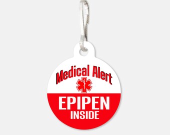 May include: White round medical alert tag with a red star of life symbol and the text "Medical Alert" in black. The bottom half of the tag is red with the text "EPIPEN INSIDE" in white.