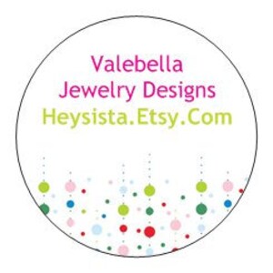 May include: A white circle with the text "Valebella Jewelry Designs Heysista.Etsy.Com" in pink and green. The bottom of the circle is decorated with a row of colorful dots.