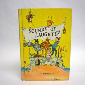 May include: A vintage children's book cover with a yellow background and the title "Sounds of Laughter" in black text. The cover features illustrations of animals, including a giraffe, a donkey, and a bird, as well as children.