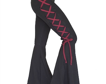 May include: Black flared pants with a red lace-up detail on the side.
