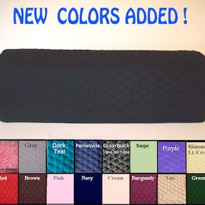 May include: A black quilted fabric item with rounded ends, possibly a furniture cover. The image includes a color chart with options like gray, teal, periwinkle, sage, and burgundy. Text reads "NEW COLORS ADDED!"
