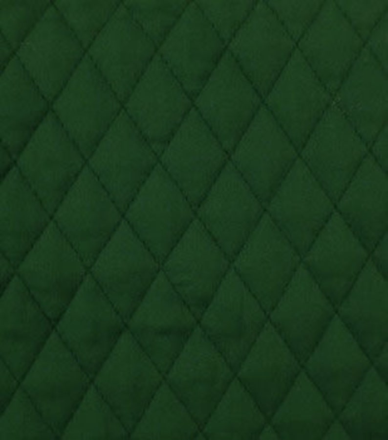 May include: Close-up of a dark green quilted fabric with a diamond pattern. The stitching creates a grid of evenly spaced, raised diamonds across the surface. The fabric has a soft, matte appearance.