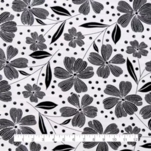 May include: Black and white floral fabric with a repeating pattern of stylized flowers, leaves, and dots. The flowers have detailed petals and are arranged on a white background. The ruler at the bottom shows inches.