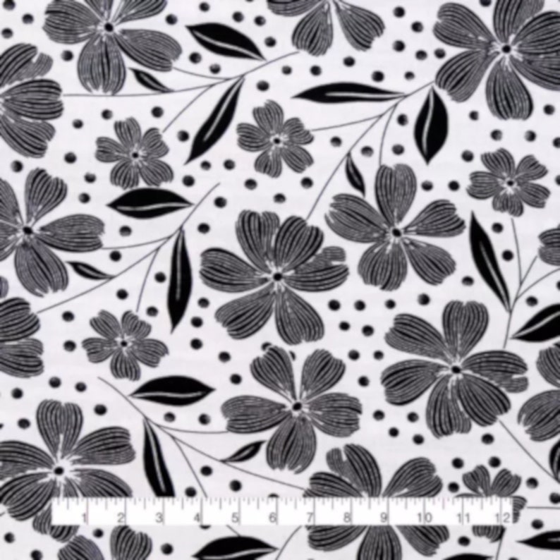 May include: Black and white floral fabric with a repeating pattern of stylized flowers, leaves, and dots. The flowers have detailed petals and are arranged on a white background. The ruler at the bottom shows inches.