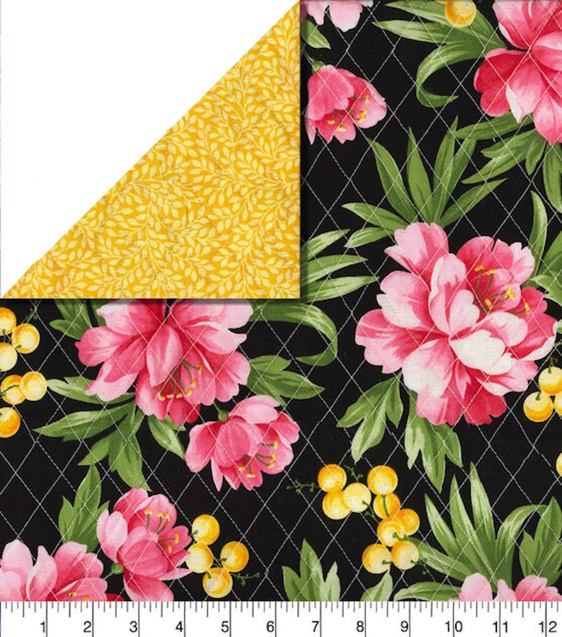 May include: A floral fabric with a black background, featuring large pink peony blooms, green leaves, and yellow berries. The fabric is quilted with white thread in a diamond pattern. The corner reveals a yellow fabric with a leaf pattern.