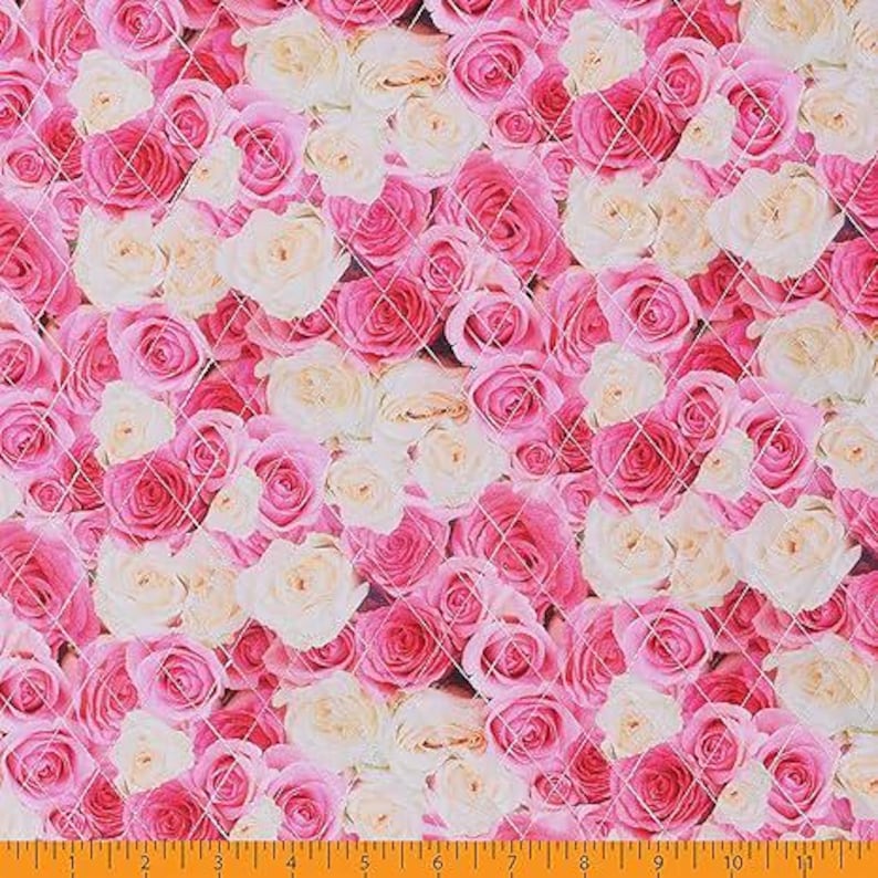 May include: A fabric with a repeating pattern of pink and cream-colored roses. The roses are densely packed and arranged in a quilted design. The background is a light pink color.