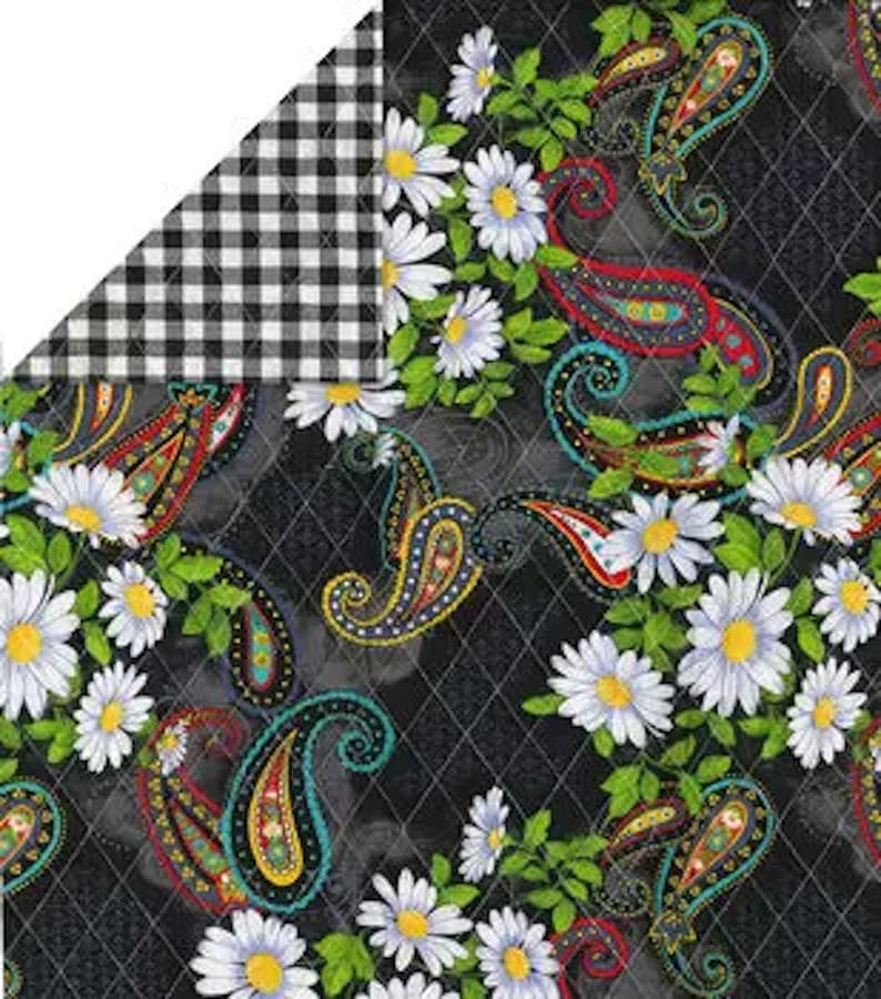 May include: Reversible fabric with a black and white gingham pattern on one side and a floral paisley design on the other. The paisley pattern features white daisies, green leaves, and colorful paisley shapes on a black diamond-patterned background.