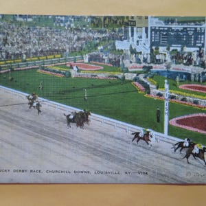 May include: Vintage postcard depicting the Kentucky Derby Race at Churchill Downs in Louisville, KY. The image shows horses racing on a track, with spectators in the background. The finish line is marked with a sign. The postcard is a historical item.