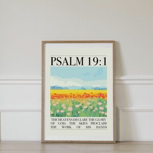 Pode incluir: Uma impressão emoldurada com uma cena de paisagem colorida e o texto "PSALM 19:1 THE HEAVENS DECLARE THE GLORY OF GOD; THE SKIES PROCLAIM THE WORK OF HIS HANDS".