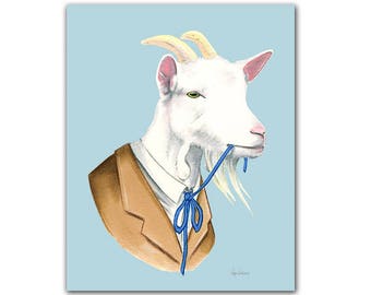 Puede incluir: Una cabra blanca con un traje marrón y una corbata de lazo azul. La cabra está masticando la corbata de lazo azul.