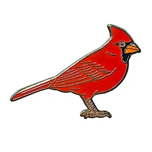 May include: A red cardinal bird with a black eye stripe and a yellow beak. The bird is depicted in a side profile with its wings folded and its tail feathers spread out.