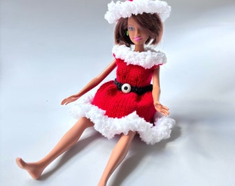 Dress and hat for fashion doll 11.5”.  Hand knit in the USA. Santa’s helper. Red dress with fluffy white trim. Matching hat.