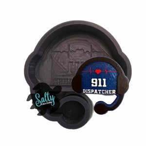 May include: A black cookie cutter in the shape of a 911 dispatcher headset with a heartbeat design and the text "911 DISPATCHER". A black turtle with the text "Salty Creations" is also visible.