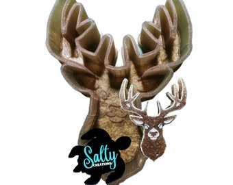 May include: A brown plastic deer head cookie cutter with a detailed design. The cutter is made by Salty Creations.